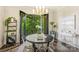 A stylish dining room with a modern chandelier overlooks a large balcony at 622 Mattie Rose Ln, Charlotte, NC 28204