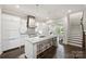 View of the kitchen flowing to the living room, featuring a center island and stainless hood at 622 Mattie Rose Ln, Charlotte, NC 28204
