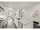 An open concept kitchen with quartz countertops and stainless appliances flows to the living room and stairway at 622 Mattie Rose Ln, Charlotte, NC 28204
