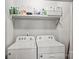 Functional laundry room with a washer, dryer, and storage shelves at 622 Mattie Rose Ln, Charlotte, NC 28204