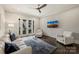 Cozy living room featuring a ceiling fan, modern decor, and a bright view from glass paneled doors at 622 Mattie Rose Ln, Charlotte, NC 28204