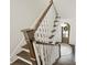 View from the top of the stairs showing the wood treads, white wainscoting, and front entrance at 622 Mattie Rose Ln, Charlotte, NC 28204