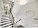 Elegant staircase with dark wood treads, white risers and wainscoting, and a decorative mirror at 622 Mattie Rose Ln, Charlotte, NC 28204