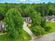 Aerial view showing the house from above, highlighting its location among mature trees at 6530 Fly A Way Dr, Denver, NC 28037