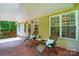 Outdoor patio featuring wood deck, reclining chairs, end table, and natural lighting at 6530 Fly A Way Dr, Denver, NC 28037