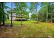 House in backyard with trees and grass at 6530 Fly A Way Dr, Denver, NC 28037