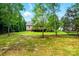 View of back of house with deck overlooking a large, shaded backyard at 6530 Fly A Way Dr, Denver, NC 28037