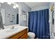 Bathroom featuring vanity sink, blue shower curtain, and neutral paint at 6530 Fly A Way Dr, Denver, NC 28037