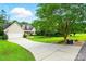 View of the exterior showcasing a long driveway leading up to a well-maintained home at 6530 Fly A Way Dr, Denver, NC 28037