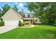 Charming home featuring a manicured lawn, two-car garage, and inviting front porch at 6530 Fly A Way Dr, Denver, NC 28037