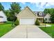Exterior shot of the home's facade, featuring a wide garage and well-manicured landscaping at 6530 Fly A Way Dr, Denver, NC 28037