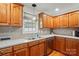 Traditional kitchen featuring wood cabinets, stainless steel dishwasher, and laminate countertops at 6530 Fly A Way Dr, Denver, NC 28037