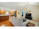 Open-concept living room flows into the kitchen, features hardwood floors and bright natural light at 6530 Fly A Way Dr, Denver, NC 28037