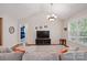 Bright living room with vaulted ceilings, hardwood floors, and a large window at 6530 Fly A Way Dr, Denver, NC 28037