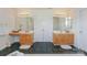 Double vanity bathroom featuring separate sinks and a shared central linen closet at 6873 Lakecrest Ct, Denver, NC 28037