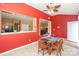 Dining room with red accent wall and large windows, adjacent to kitchen and living areas at 6873 Lakecrest Ct, Denver, NC 28037