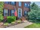 Inviting brick porch with decorative landscaping and an American flag at 6873 Lakecrest Ct, Denver, NC 28037