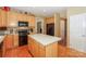 A spacious kitchen boasts an island, natural wood cabinets and opens to other rooms at 6873 Lakecrest Ct, Denver, NC 28037