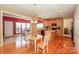 Open kitchen with wood cabinets and island, flowing into the bright dining area at 6873 Lakecrest Ct, Denver, NC 28037