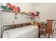 Functional laundry room featuring a washer, dryer, and ample storage shelving at 6873 Lakecrest Ct, Denver, NC 28037