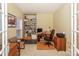 Well-lit home office with built-in shelving, desk, and comfortable seating at 6873 Lakecrest Ct, Denver, NC 28037