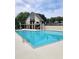 Community pool with clear blue water, featuring a two-story pool house and surrounding greenery at 6873 Lakecrest Ct, Denver, NC 28037