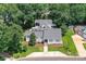Aerial view of a gray roof home with lush trees surrounding it at 7010 Coventry Ct, Tega Cay, SC 29708