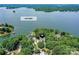 An aerial view shows the home nestled in a wooded area with lake access to Lake Wylie at 7010 Coventry Ct, Tega Cay, SC 29708