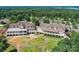 Aerial view of clubhouse with expansive porches, manicured lawns, and winding pathways at 7010 Coventry Ct, Tega Cay, SC 29708