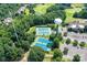 Aerial view features tennis courts, a water tower, and a golf course, highlighting recreational amenities at 7010 Coventry Ct, Tega Cay, SC 29708