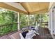 Comfortable outdoor balcony seating with views of mature landscaping and the lake at 7010 Coventry Ct, Tega Cay, SC 29708