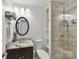 Bathroom featuring single vanity, shower and built-in shelves at 7010 Coventry Ct, Tega Cay, SC 29708