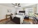 Bedroom featuring hardwood floors, ceiling fan and dark wood furniture at 7010 Coventry Ct, Tega Cay, SC 29708