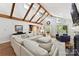 Spacious living room with vaulted ceilings, exposed wood beams, and an elegant sectional sofa at 7010 Coventry Ct, Tega Cay, SC 29708