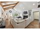 A bright living room with vaulted ceilings, wood beams, a fireplace, and a large sectional sofa at 7010 Coventry Ct, Tega Cay, SC 29708