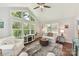 Bright living room featuring vaulted ceilings, modern ceiling fan, and an abundance of natural light at 7010 Coventry Ct, Tega Cay, SC 29708