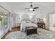 Spacious main bedroom with a ceiling fan, hardwood floors, and a decoratively styled area rug at 7010 Coventry Ct, Tega Cay, SC 29708