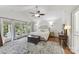 Spacious main bedroom with a ceiling fan, hardwood floors and access to a private balcony at 7010 Coventry Ct, Tega Cay, SC 29708