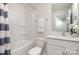 All white bathroom offers a shower/tub combo, toilet and sink with a vanity at 7109 N Mills Rd, Charlotte, NC 28216