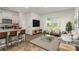 Well-lit living space features a kitchen with a breakfast bar, and a comfortable sitting area at 7109 N Mills Rd, Charlotte, NC 28216