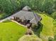 Beautiful aerial view showing the brick home, manicured lawn, mature landscaping, and detached garage at 7612 Maple Bluff Ln, Concord, NC 28025