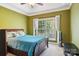 This beautiful bedroom has a tray ceiling, a ceiling fan and lots of natural light at 7612 Maple Bluff Ln, Concord, NC 28025