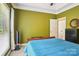 A carpeted bedroom with a ceiling fan, closet and light-filled windows at 7612 Maple Bluff Ln, Concord, NC 28025