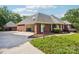 Brick home with a detached garage, providing ample parking and beautifully landscaped surroundings at 7612 Maple Bluff Ln, Concord, NC 28025