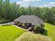 Stunning brick home featuring lush landscaping, mature trees, and a well-manicured lawn at 7612 Maple Bluff Ln, Concord, NC 28025