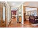 Inviting foyer showcasing hardwood floors, decorative columns, and views into the formal living spaces at 7612 Maple Bluff Ln, Concord, NC 28025