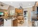 Open-concept kitchen with modern appliances, granite countertops, an island, and ample counter space at 7612 Maple Bluff Ln, Concord, NC 28025