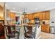 Well-appointed kitchen island with granite countertops, stylish bar stools, and ample cabinet space at 7612 Maple Bluff Ln, Concord, NC 28025