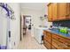 Laundry room with washer, dryer, wall cabinets, and view to additional rooms at 7612 Maple Bluff Ln, Concord, NC 28025