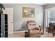 Cozy living room featuring a comfortable recliner, accent table, and a decorative piece of artwork at 7612 Maple Bluff Ln, Concord, NC 28025